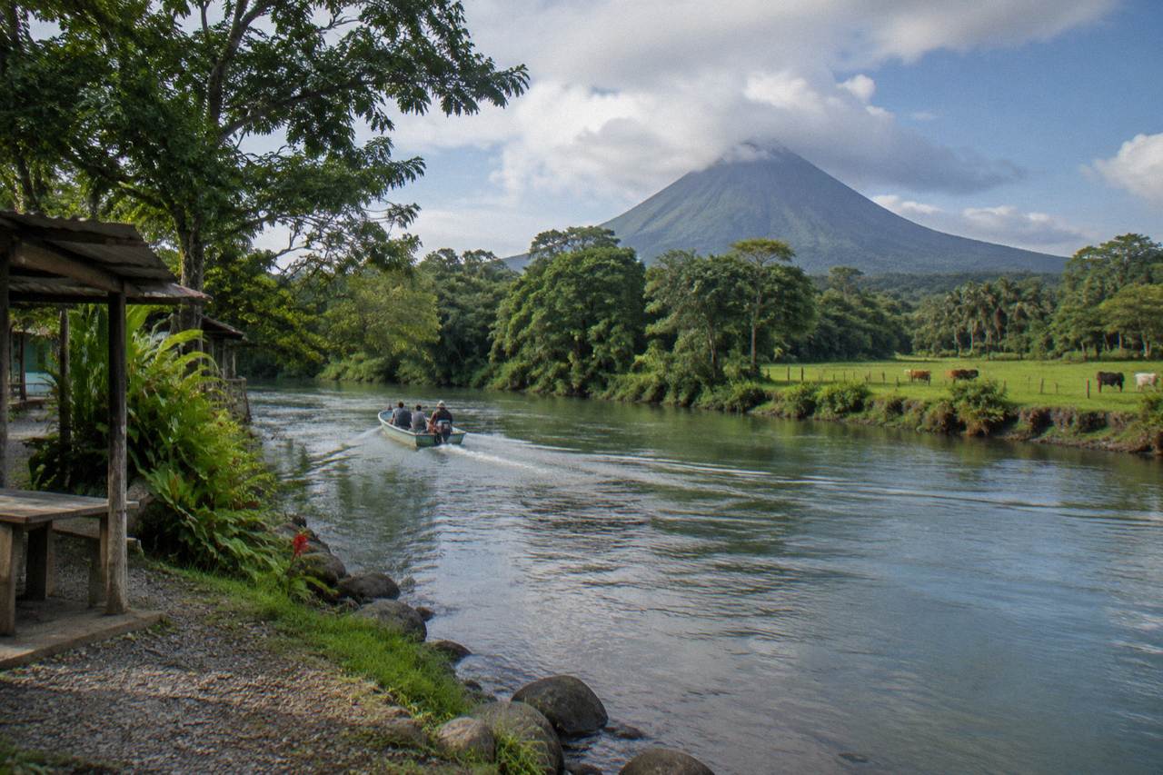A calm river winding through dense green rainforest at the base of a volcano in northern Costa Rica