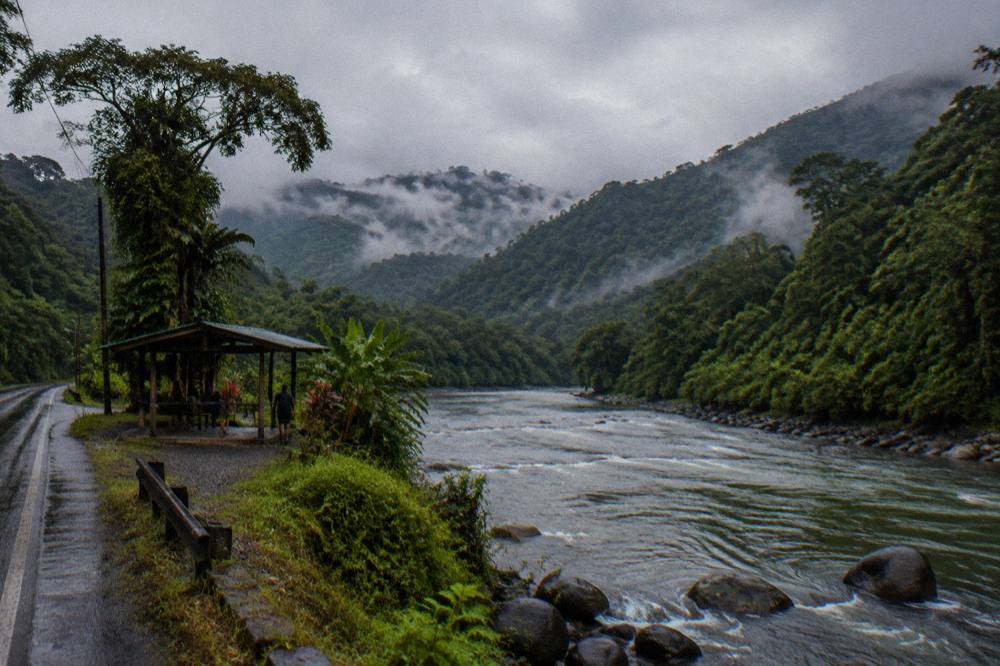 Rain clouds hanging over steep forested slopes along a mountain highway in Costa Rica